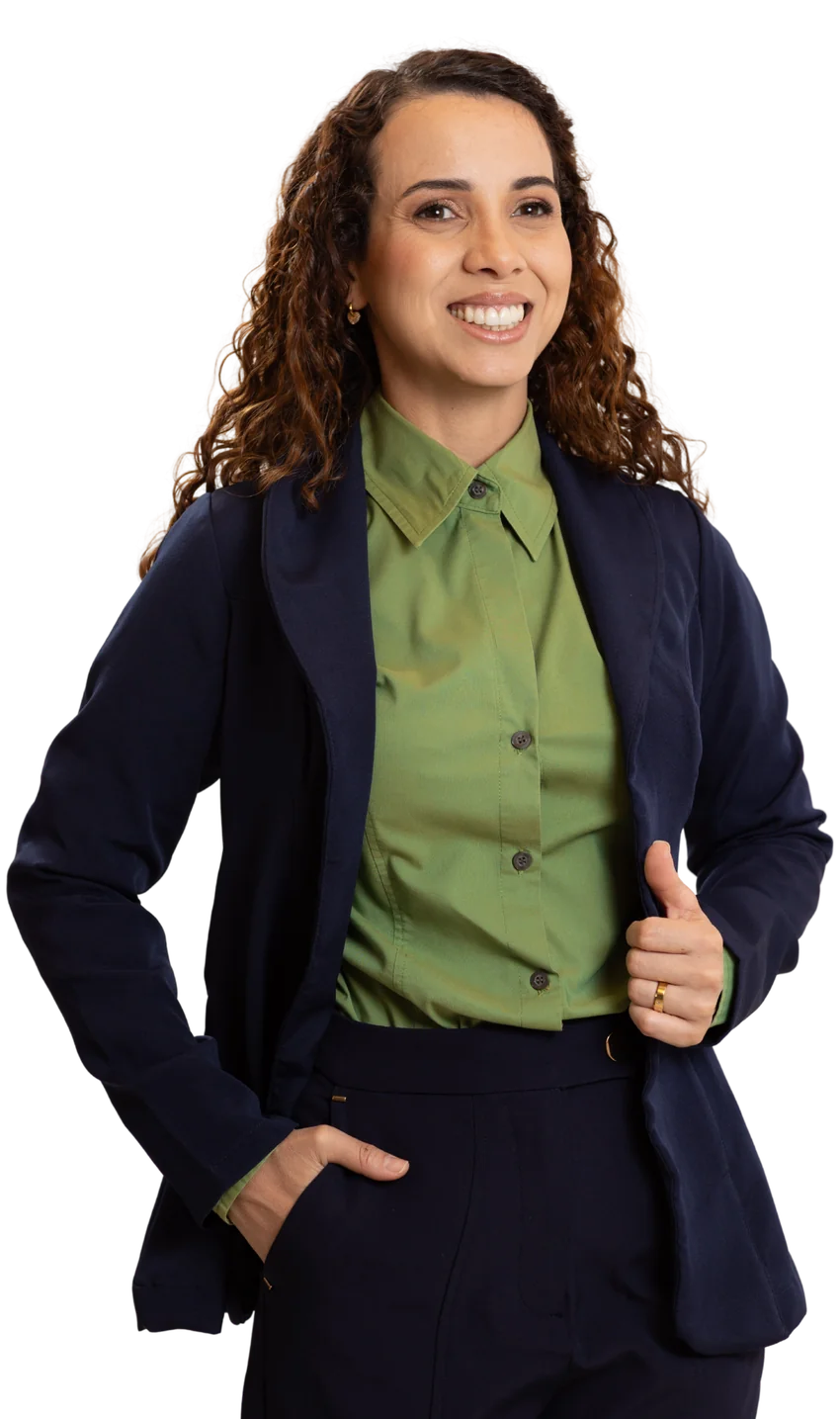 Edna Costa sorrindo, de blazer azul-marinho e blusa verde